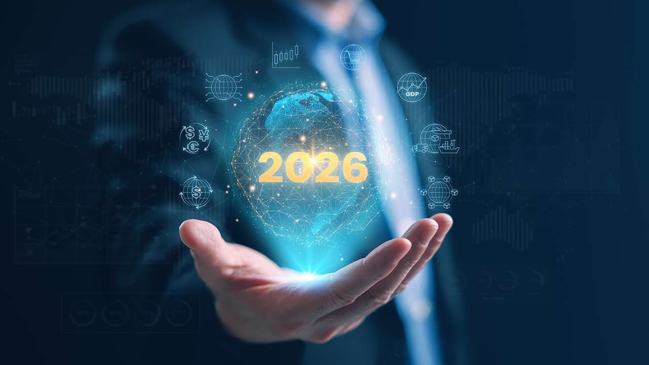 A digital graphic of the year 2026 surrounded by icons above a man's hand.