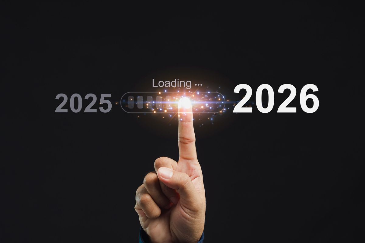 A finger pointing to a digital Loading icon between the years 2025 and 2026.