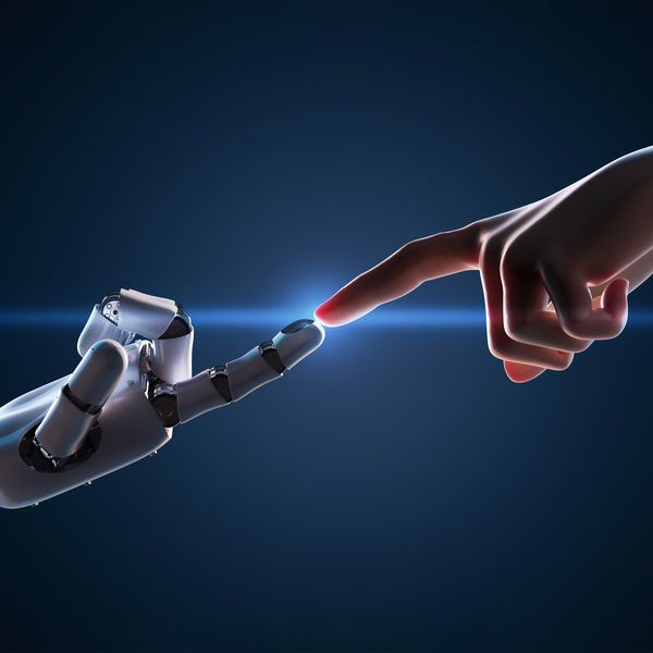 A robot finger reaches out and touches a human finger.