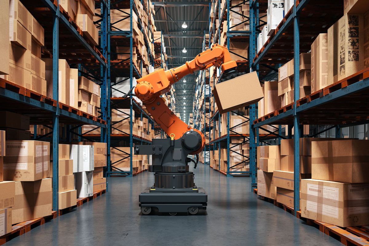A robotic arm moves boxes to a warehouse shelf.