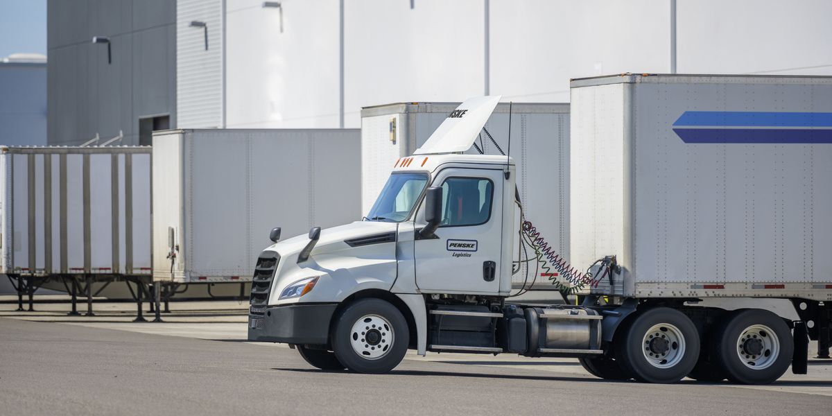 A white Penske Logistics truck delivers cargo.
