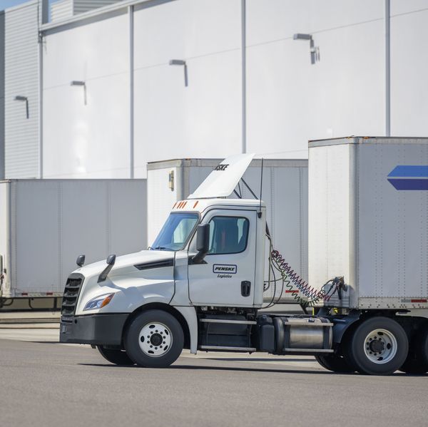 A white Penske Logistics truck delivers cargo.