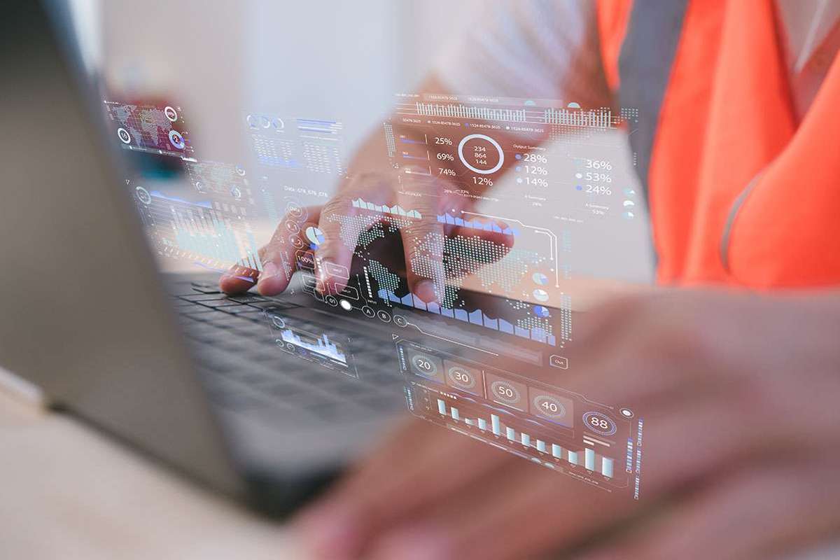 Closeup of hands typing on the keyboard of a laptop with the screen overlayed over the image.