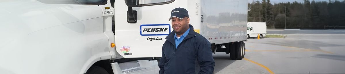 Driver standing next to Penske truck