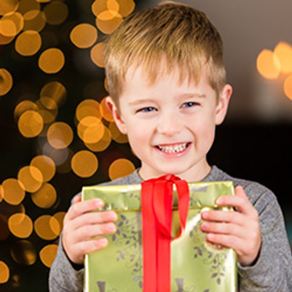 Young Boy Holding Christmas Gift