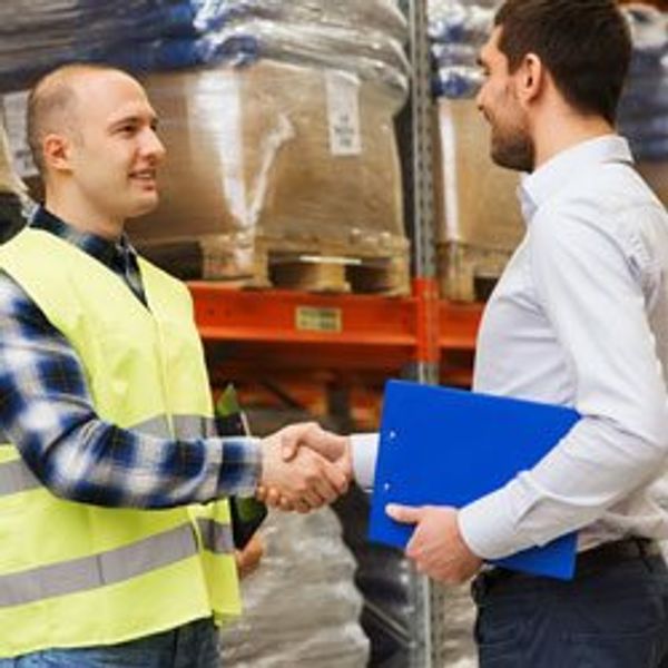 Men in warehouse shaking hands