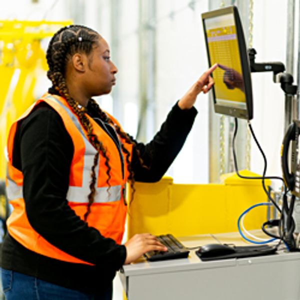 Warehouse worker viewing monitor
