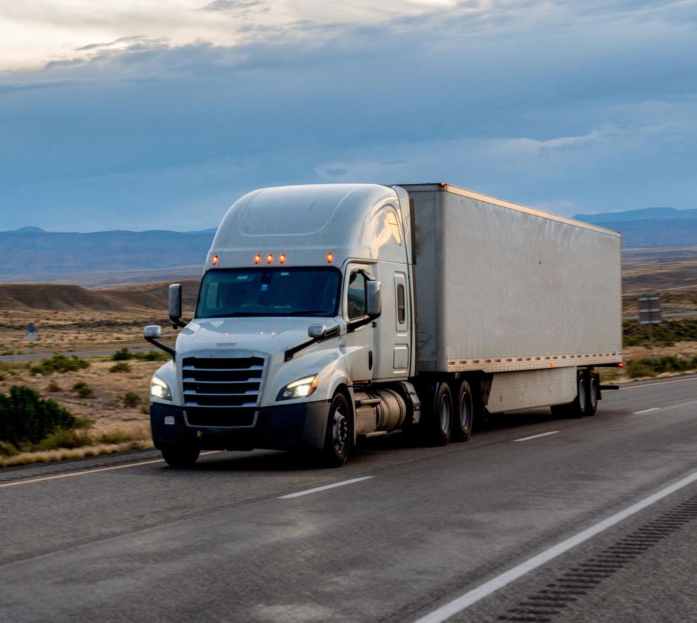 Tractor trailer hauling freight down highway