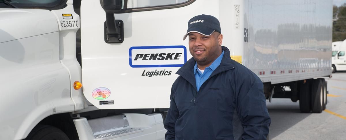 Driver standing next to Penske truck