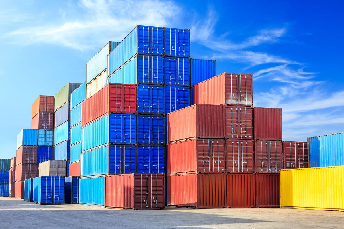 Stacked shipping containers in varying colors.