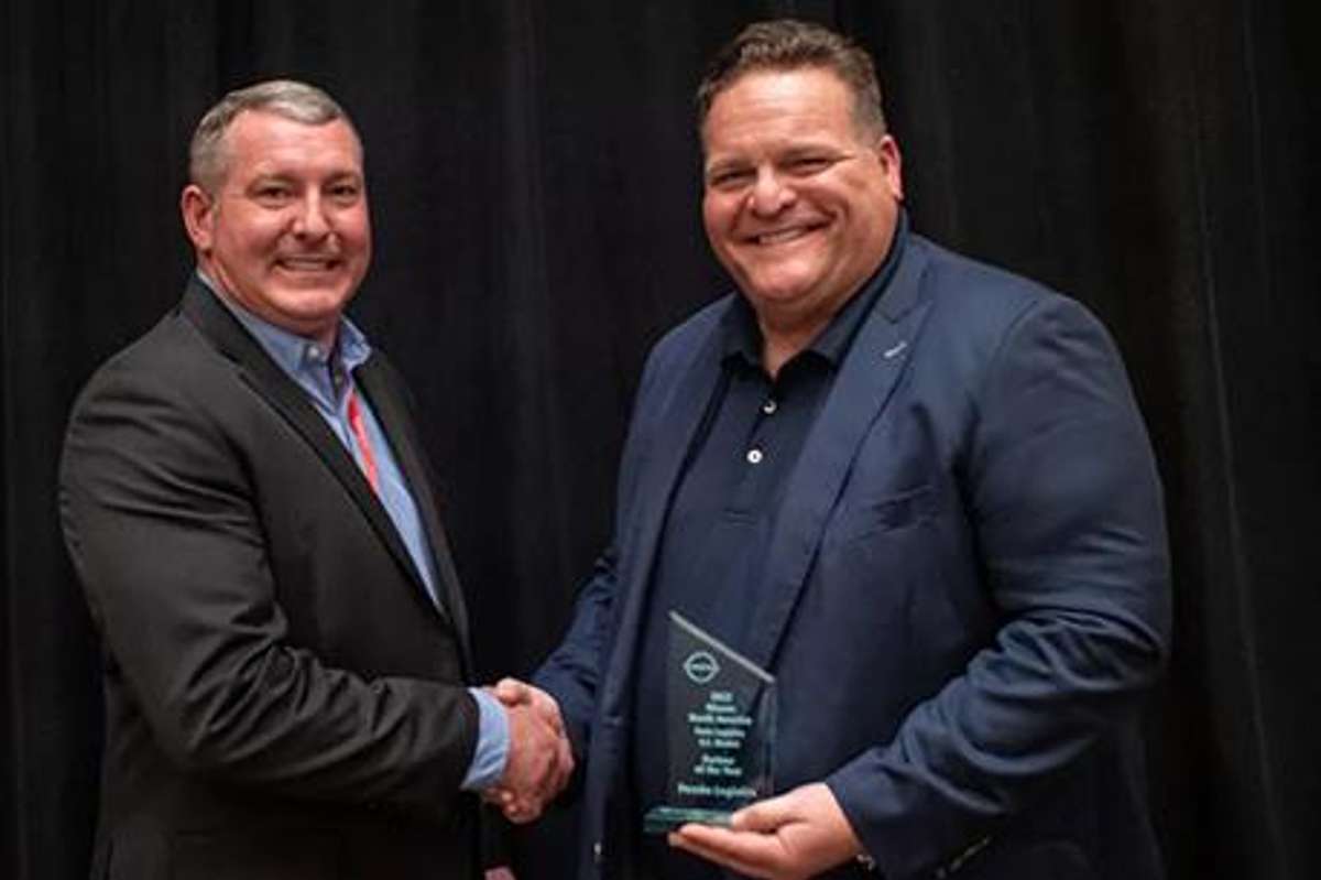 Todd Myers, Strategic Account Executive for Penske receiving Partner of the Year award from Todd Myers, Director of Parts Logistics for Nissan.