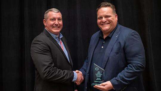 Todd Myers, Strategic Account Executive for Penske receiving Partner of the Year award from Todd Myers, Director of Parts Logistics for Nissan.