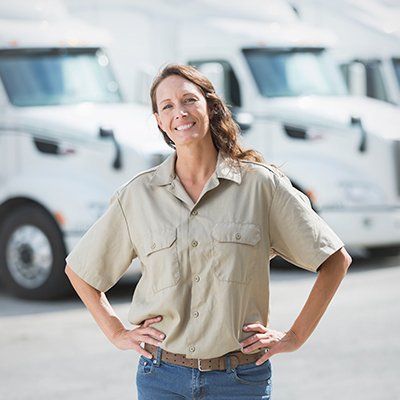 Truck driver in front of trucks