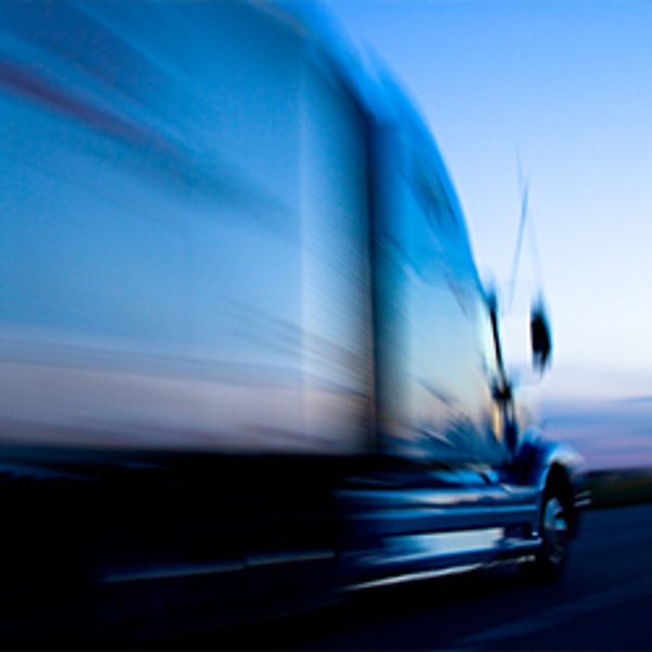 Truck Speeding Down the Freeway at Dusk