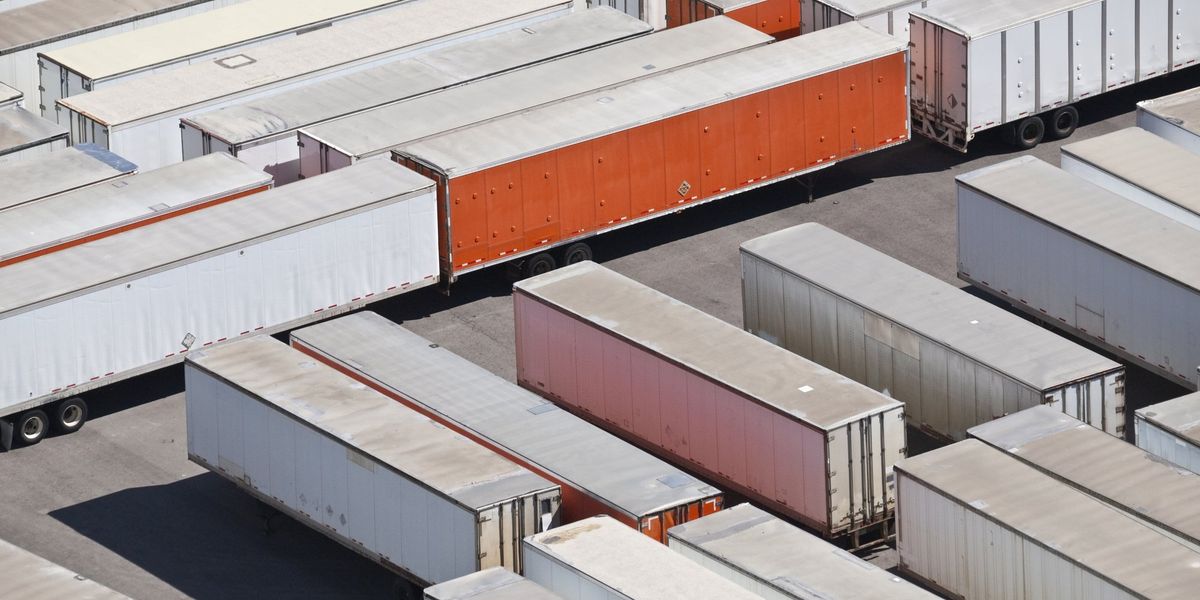 Trucks parked in a truck yard.
