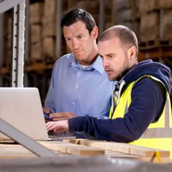 Two men looking at laptop