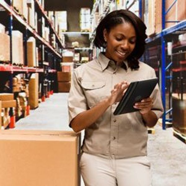 Woman in warehouse with tablet